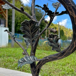 Detail of an oak twig on the wrought iron railing at the entrance to the family house