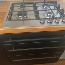 Modern forged handles on kitchen cabinet drawers  