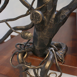 Detail of a luxury railing forged as an apple tree with a UKOVMI seal