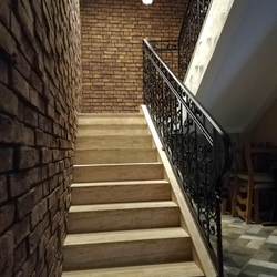 An interior staircase railing in an apartment hotel - luxury railings