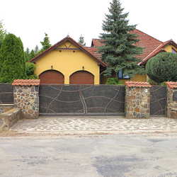 Sliding wrought-iron gate with metal filling; gate and fencing of a family house