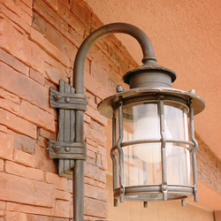A wrought iron garden lamp with glass