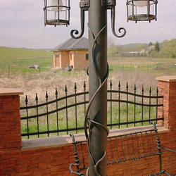 Wrought iron lights and benches in a garden