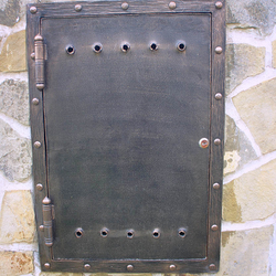 A wrought iron gas metre door