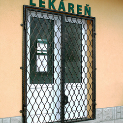 Wrought-iron grilles Wave on the door of a pharmacy in Levoča