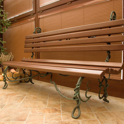A hand wrought iron bench combined with wood 