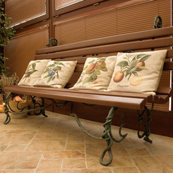 A wrought iron bench combined with wood in a winter garden with a pool