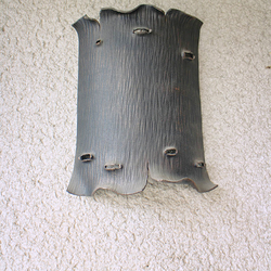 A hand wrought light designed as tree bark - luxury lamp