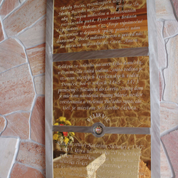 A golden plated board with a prayer in the brushed stainless steel frame in the pilgrimage place