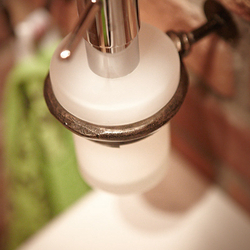 A wrought iron a soap dispenser holder