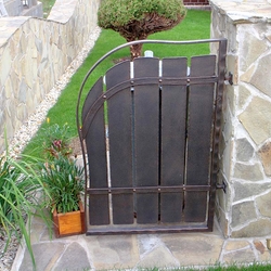 A wrought iron gate for a rubbish bin