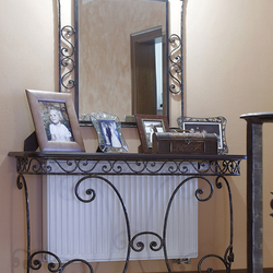 A wrought iron table with a mirror - luxury furniture
