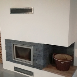 Modern interior fireplace completed with forged air intake covers