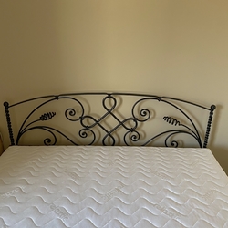 Wrought iron bed in a guest room - designer furniture