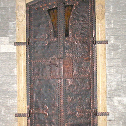 A wrought iron door in a wine cellar