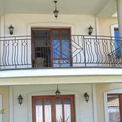 A wrought iron railing with a logo