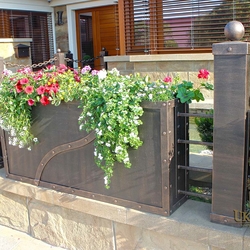 A wrought iron fence with flowerpots