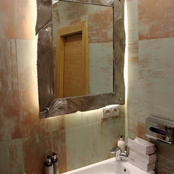 A unique stainless steel mirror in the bathroom