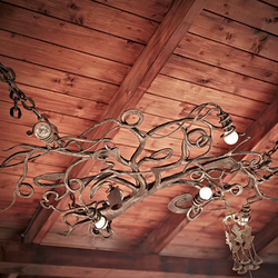 A ceiling wrought iron light in a garden summer house