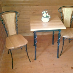 Forged table and chairs as part of the furniture in the room of the Šariš pension