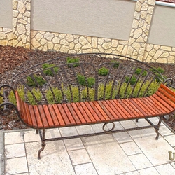 A wrought iron garden bench combined with wood