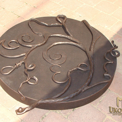 A wrought iron shaft cover