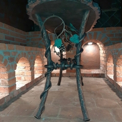 A hand-forged table with stone in the wine cellar - luxury furniture