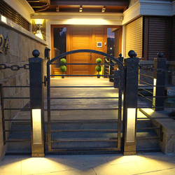 Modern entrance lighting of a wrought iron fence - luxury lights