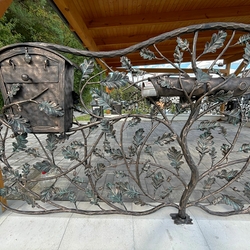 Hand-forged mailboxes embedded in luxurious fencing