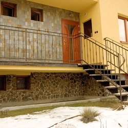 A wrought iron railing - entrance to the house - exterior railing with stairs