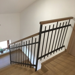 Forged interior railing with a wooden handle – simple design